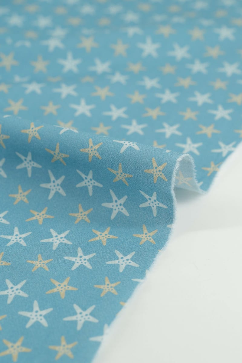 Tejido infantil con estampado de estrellas de mar